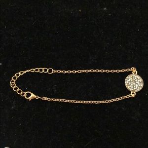 Gold tone bracelet with sparkle charm